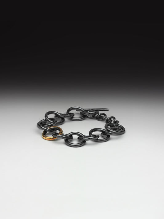 Oxidised chunky silver bracelet with gold link