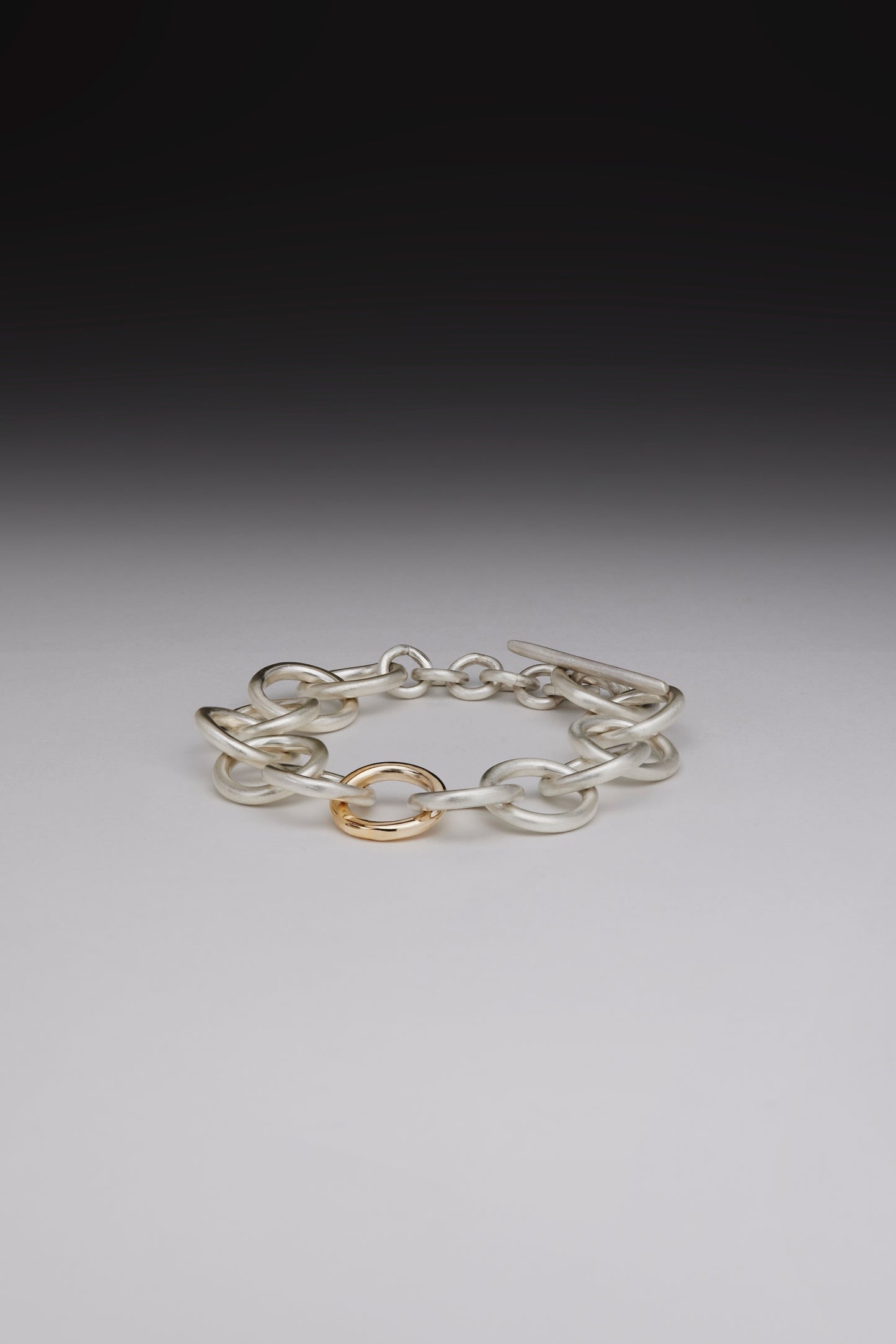 Chunky silver bracelet with gold link