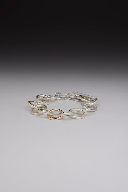 Chunky silver bracelet with gold link